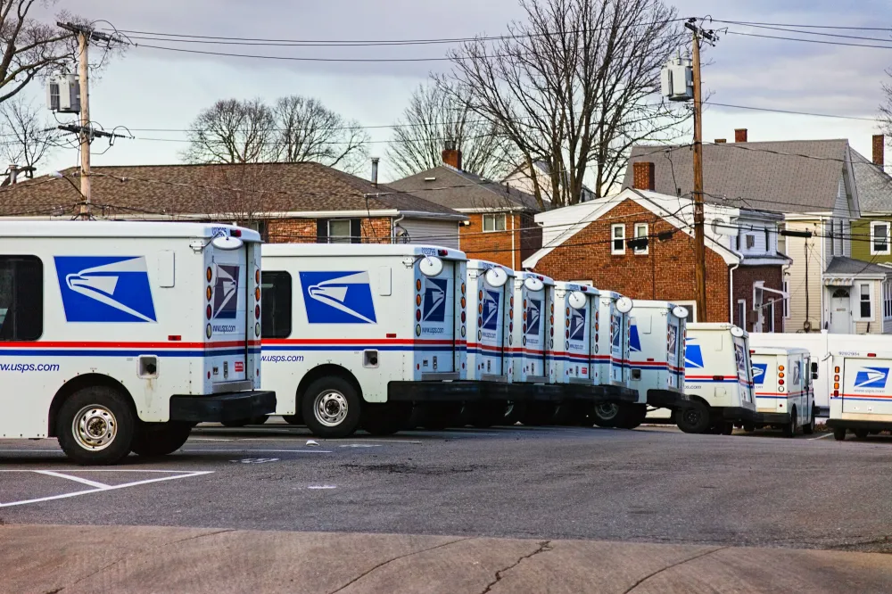 A row of fleet vans parked in a lot